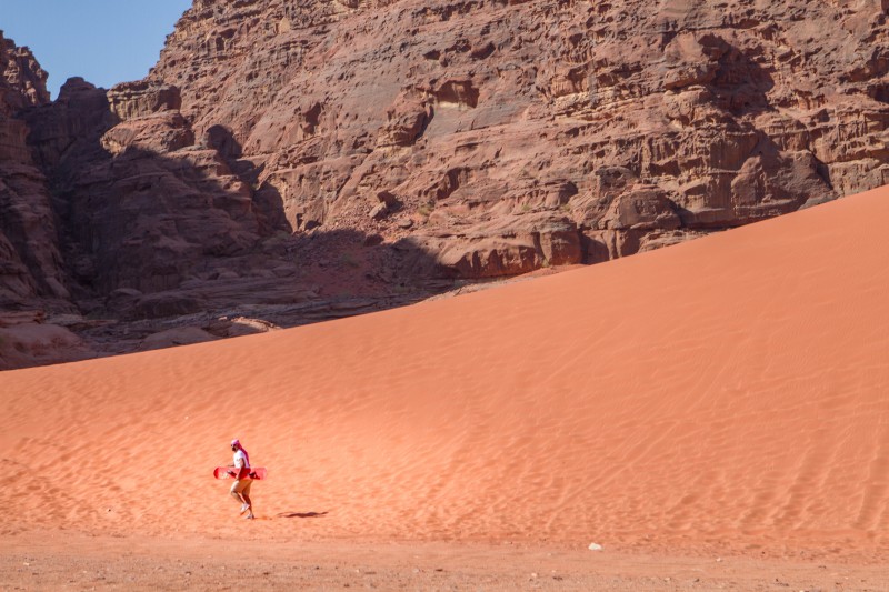 A man going sandboarding in Wadi Rum Jordan